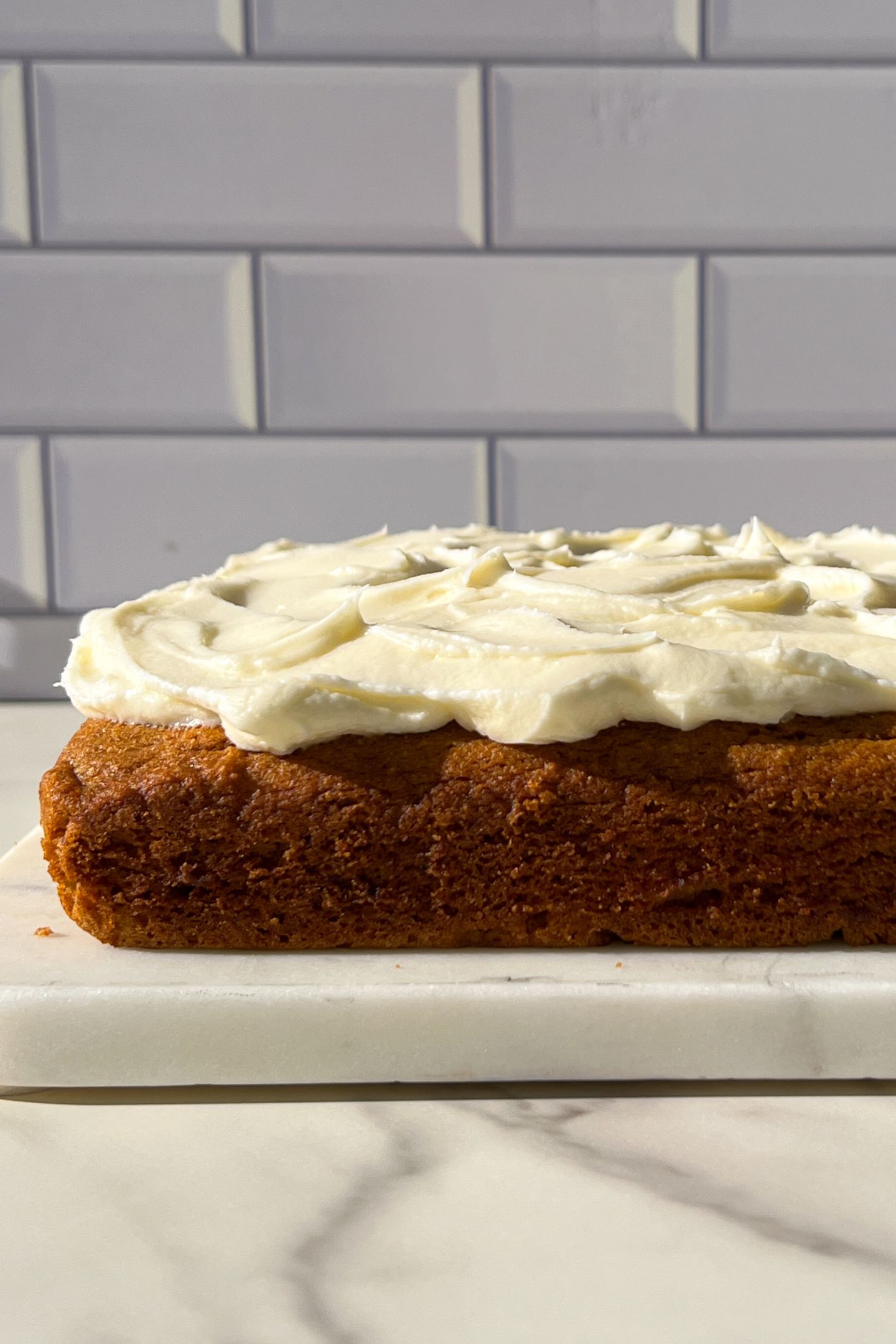 Frosting smoothed out on the pumpkin snack cake.