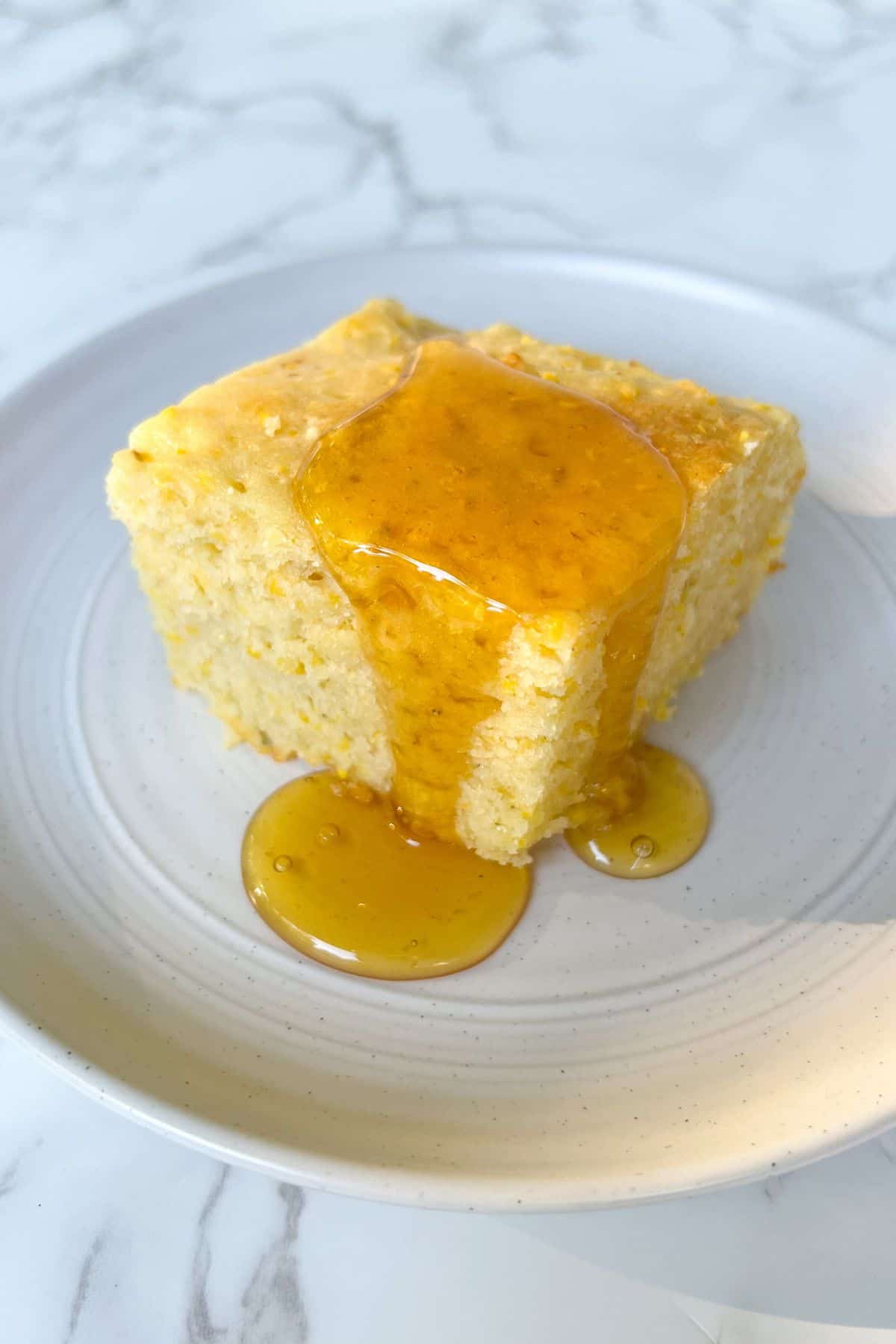 slice of cornbread topped with honey