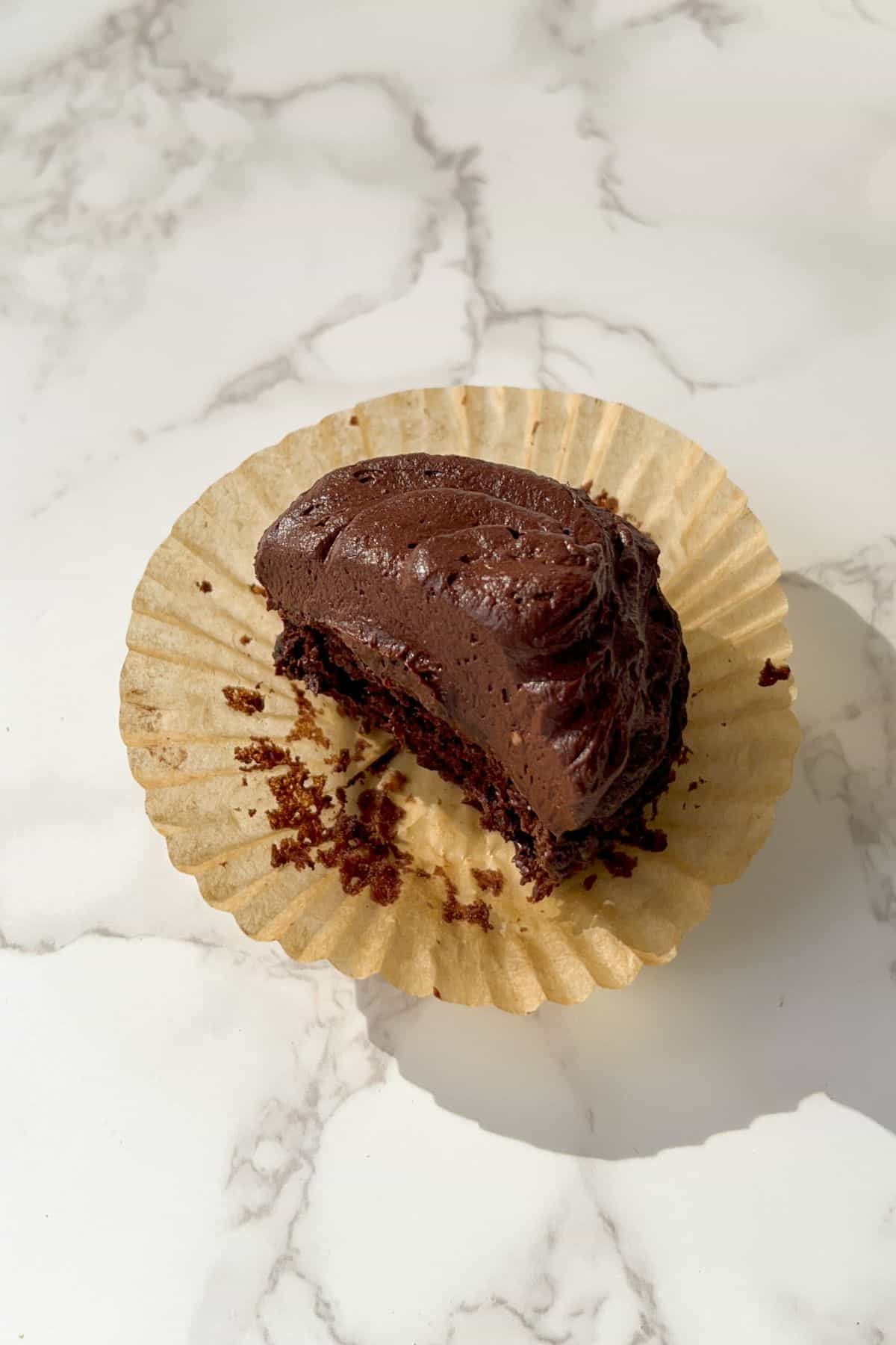 gluten free chocolate cupcake with a bite taken out of it