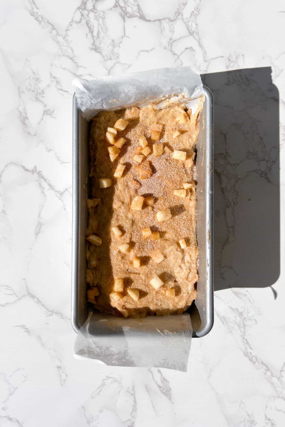apple cider donut bread batter in a loaf pan