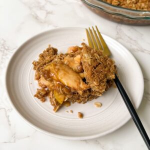 spiced apple crumble served on a plate with a fork