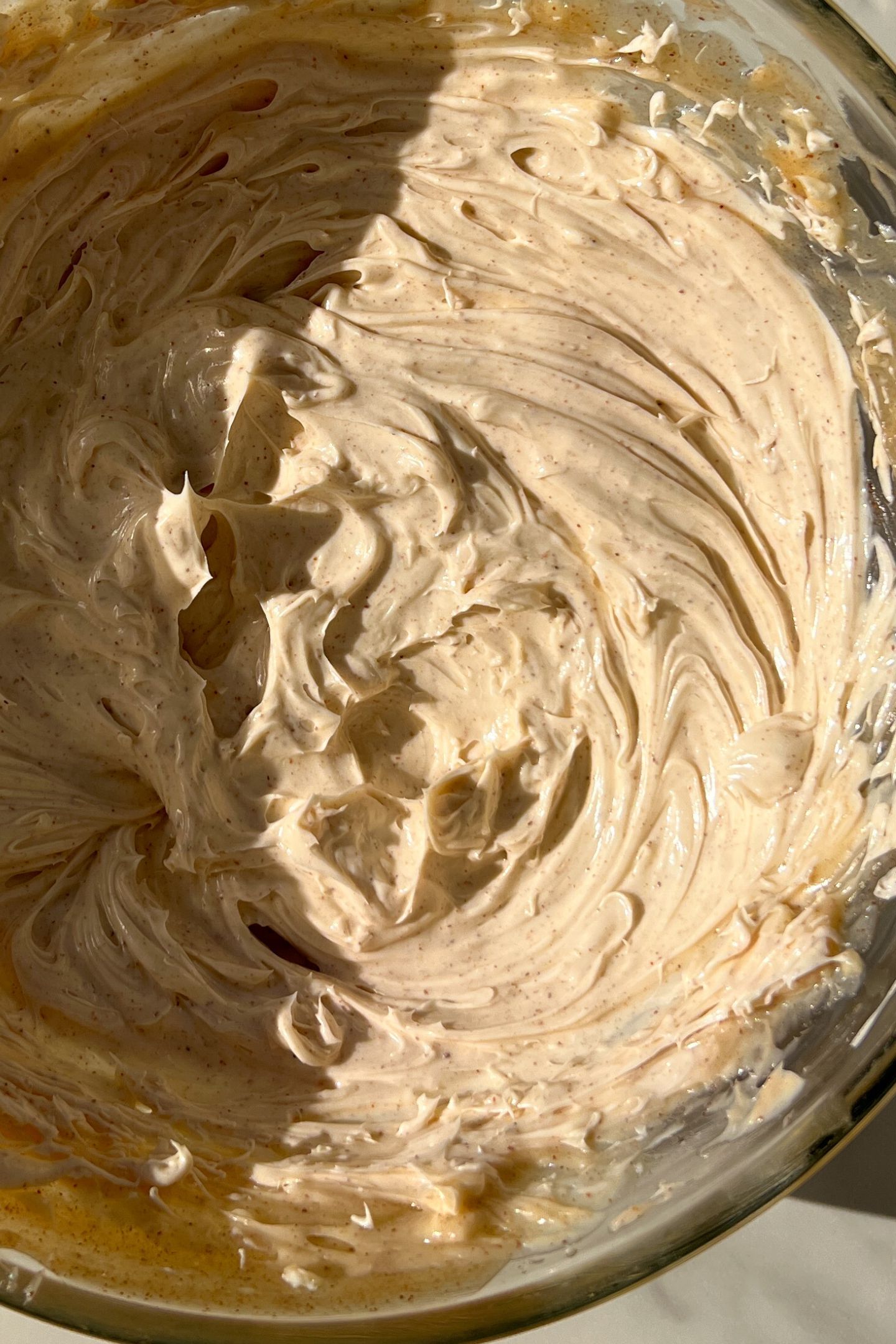 Whipped honey cinnamon butter in a bowl.