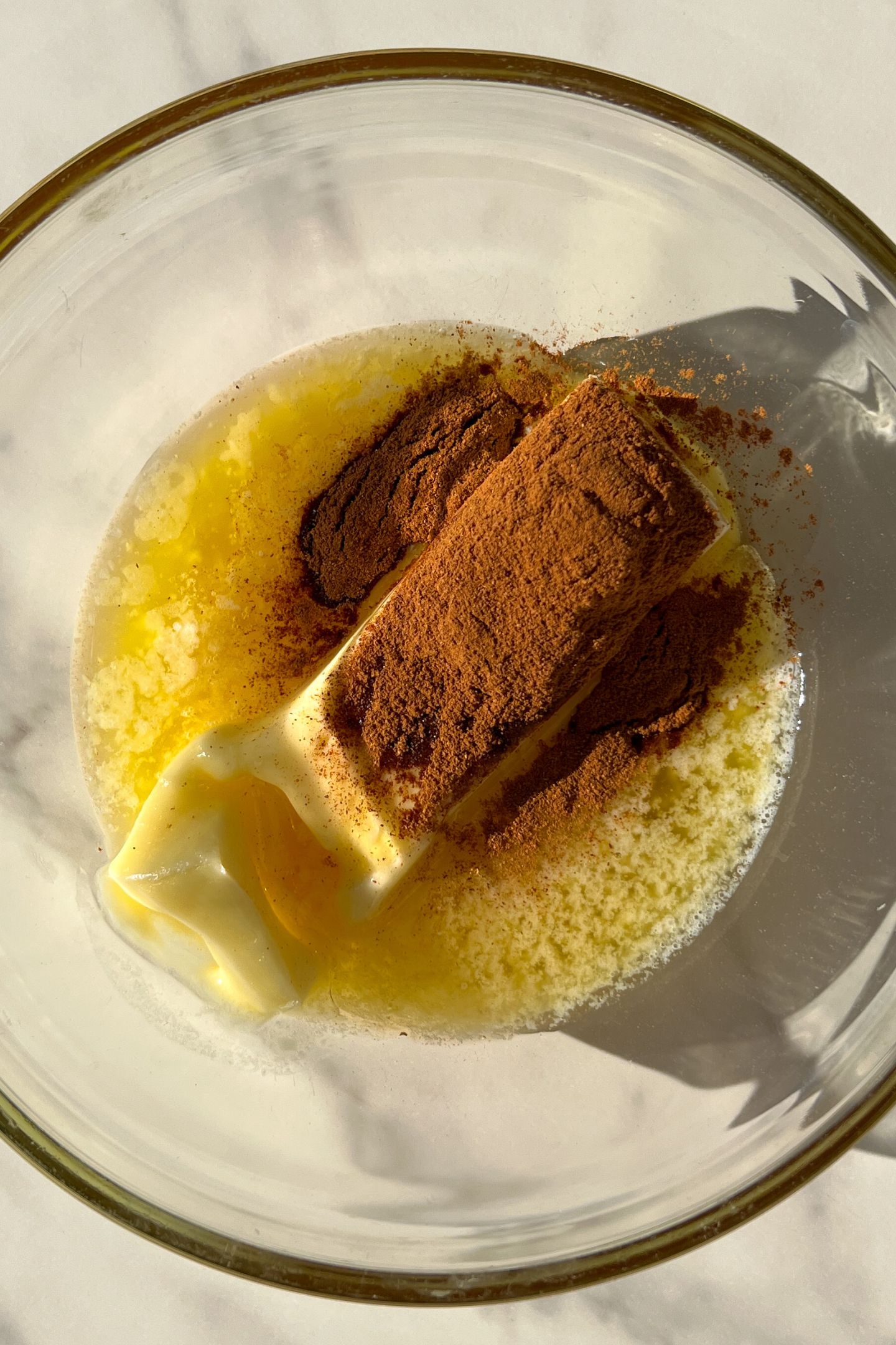 Softened butter in a bowl with honey and cinnamon.