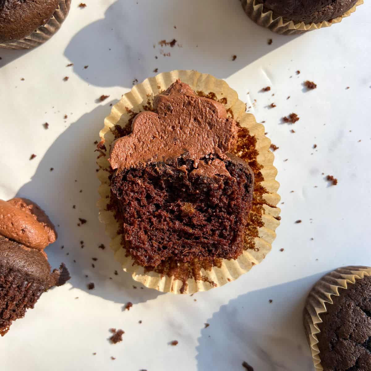 Gluten Free Chocolate Cupcake cut in half with chocolate frosting.