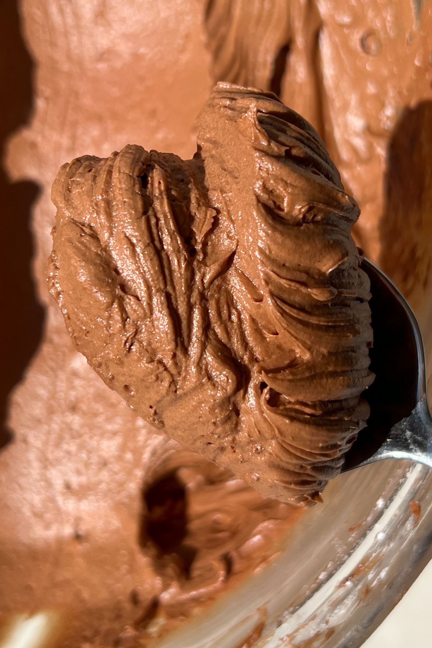Chocolate Cream cheese Frosting on a spoon.