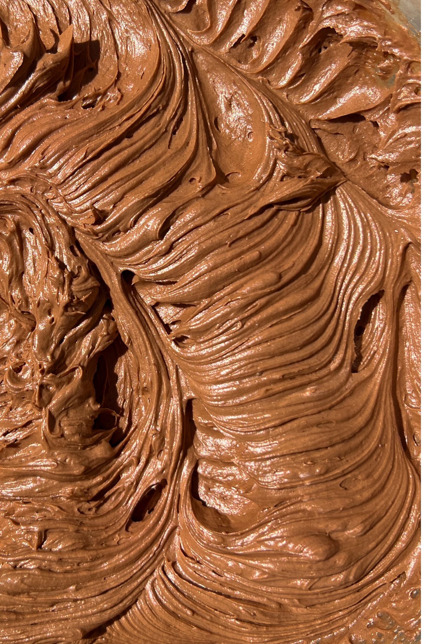 Whipped chocolate frosting in bowl.