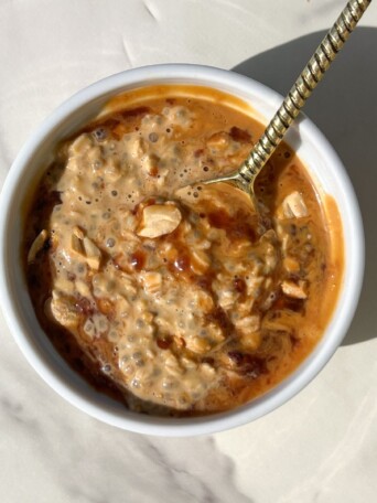 PB and J Overnight Oats topped with crushed peanuts, peanut butter and jam.