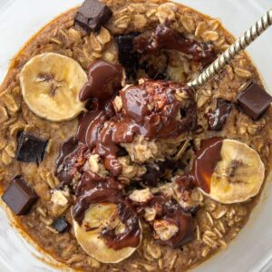 a spoon in a bowl of chocolate chip baked oats without egg