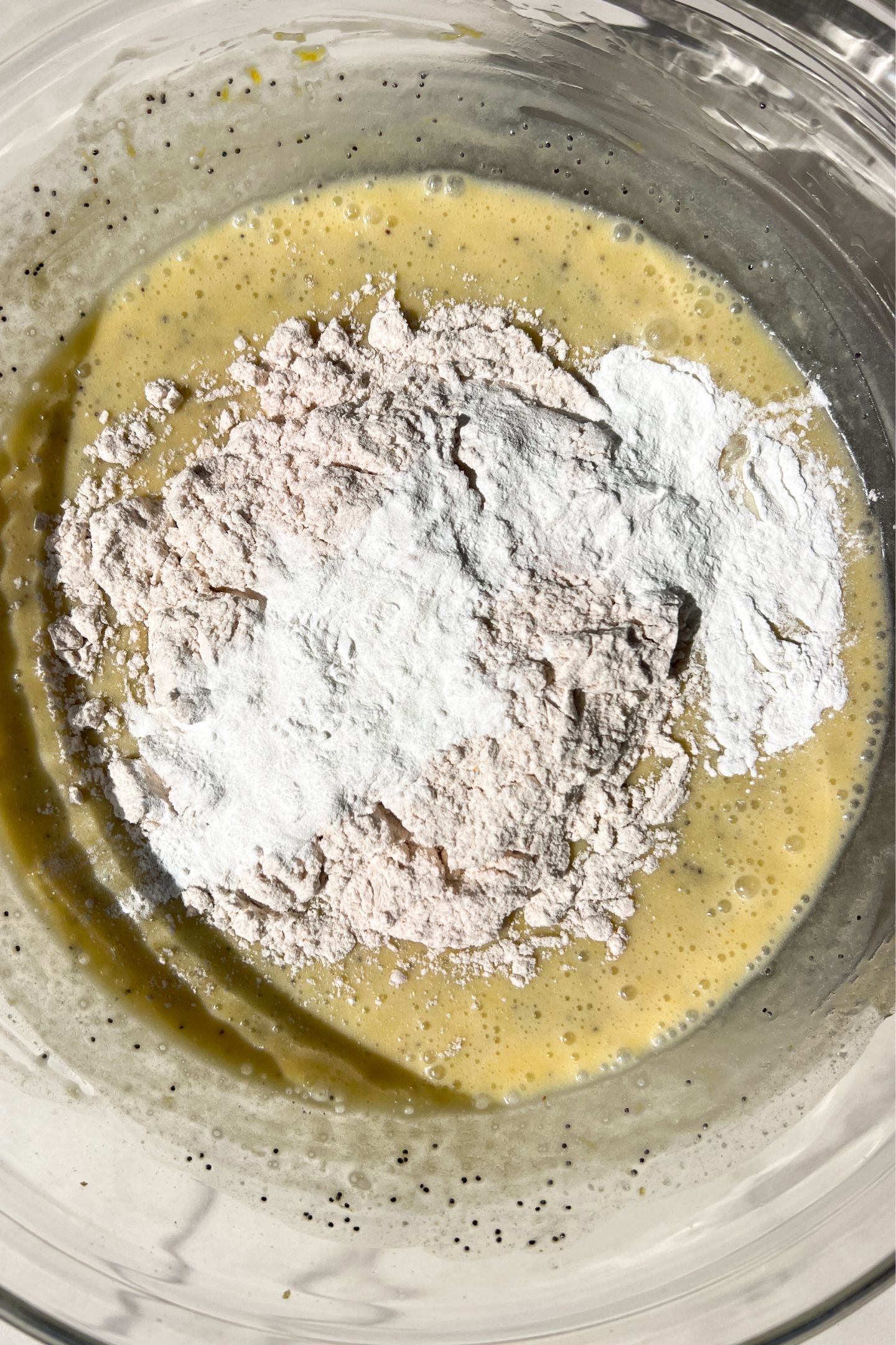 Mixing wet and dry ingredients together in the bowl.