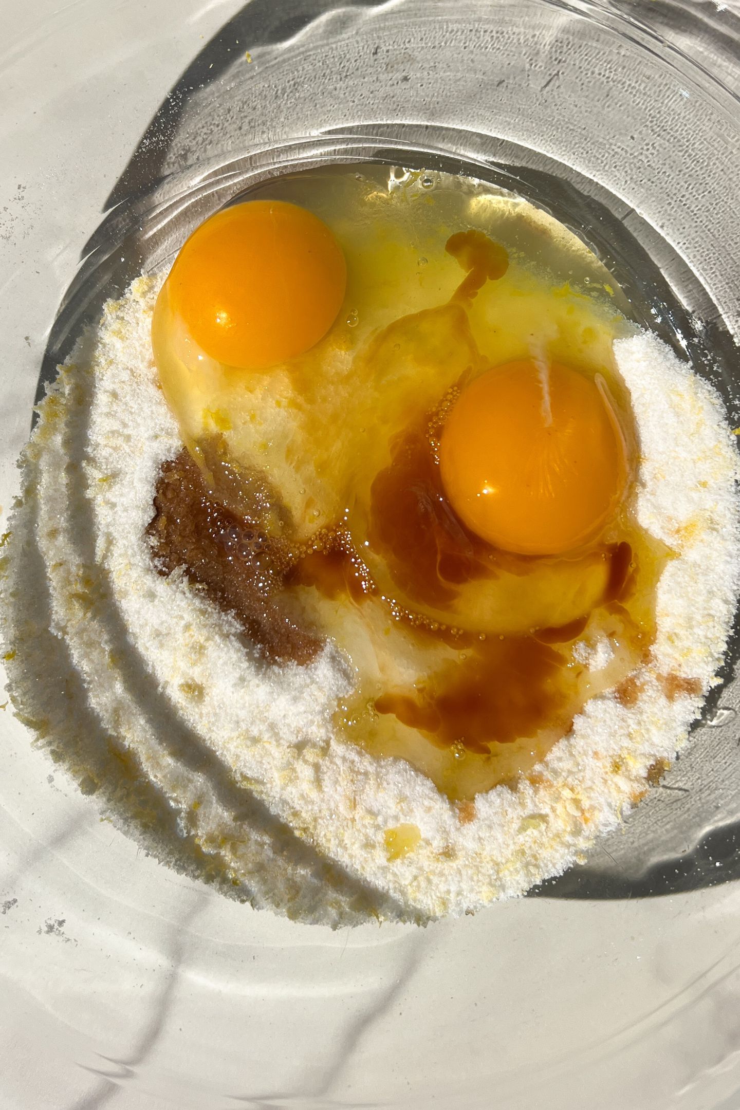 Eggs and vanilla added to sugar.