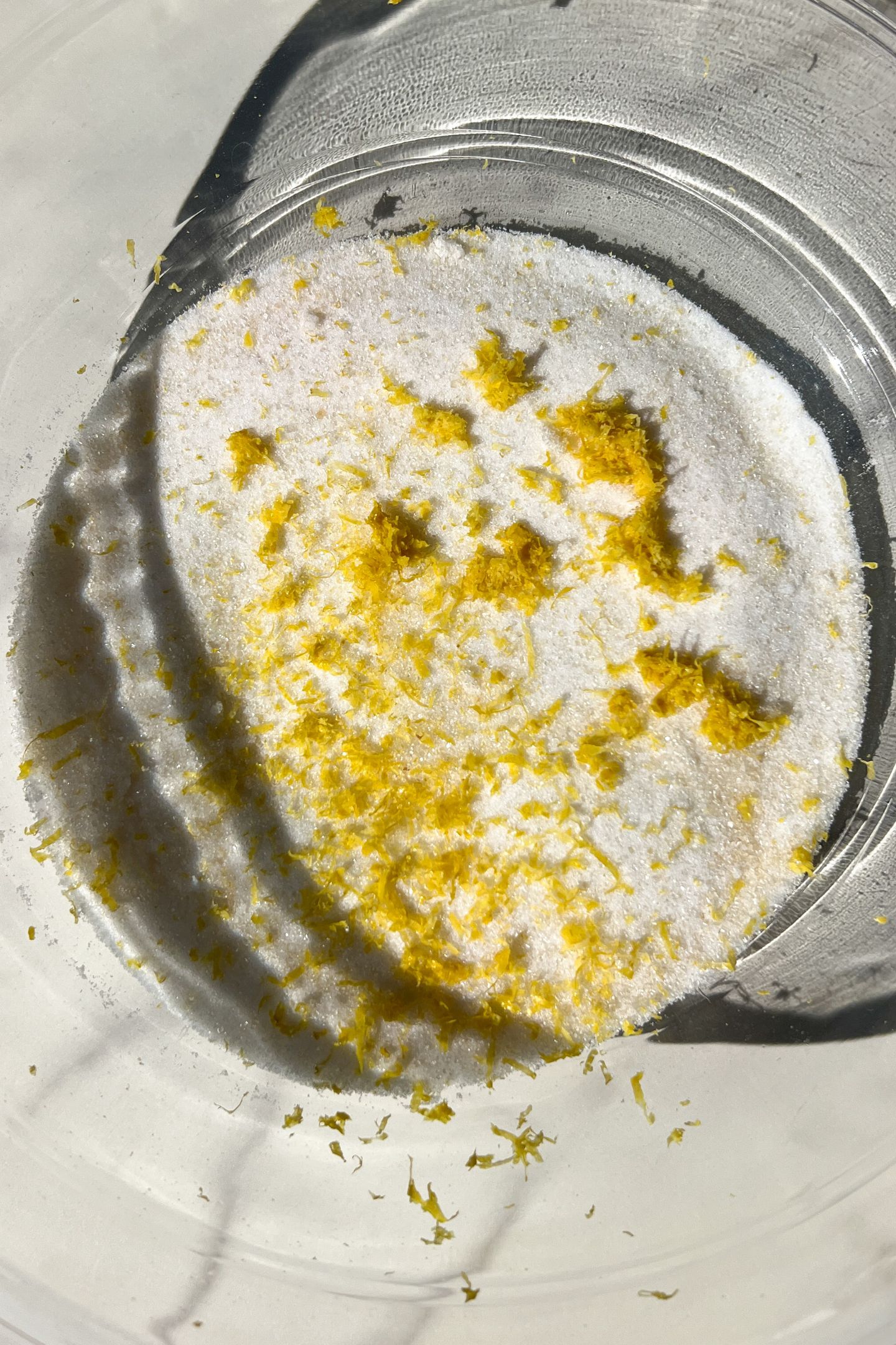 Granulated sugar and lemon zest in a large mixing bowl.