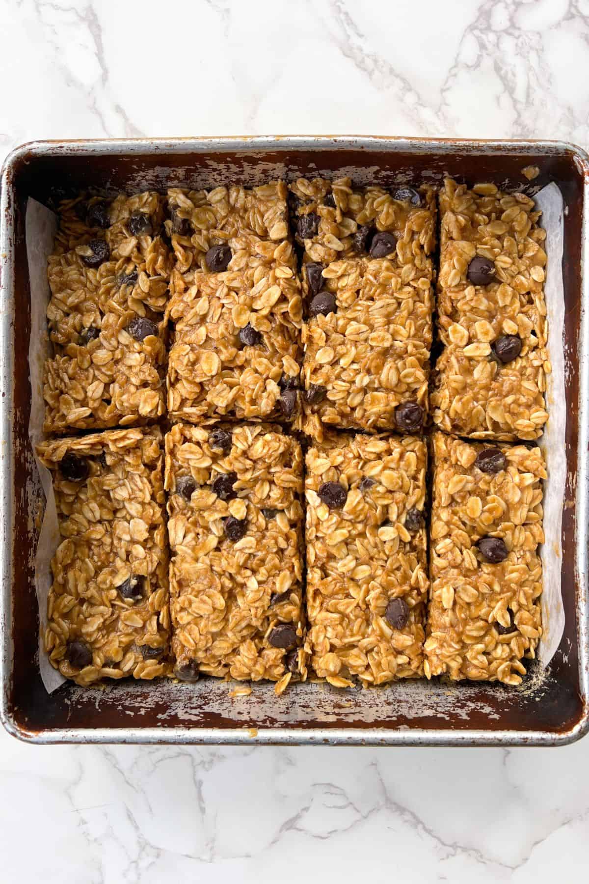 No Bake Chocolate Oat Bars with Peanut Butter sliced in an 8x8 square baking pan.