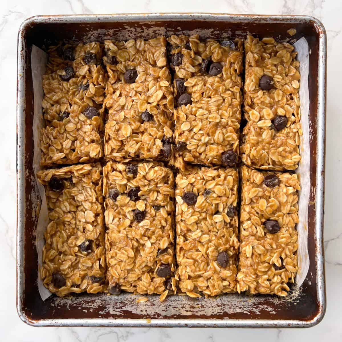 No Bake Chocolate Oat Bars with Peanut Butter sliced in an 8x8 square baking pan.