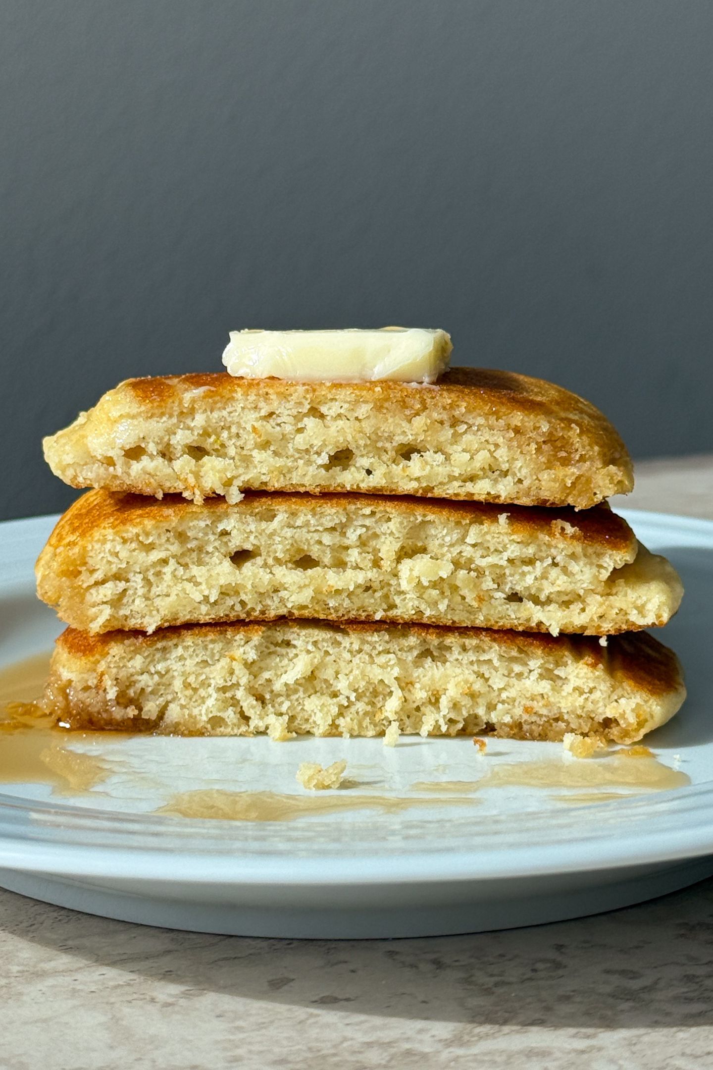 Fluffy buttermilk pancakes stacked and cut to show the inside.