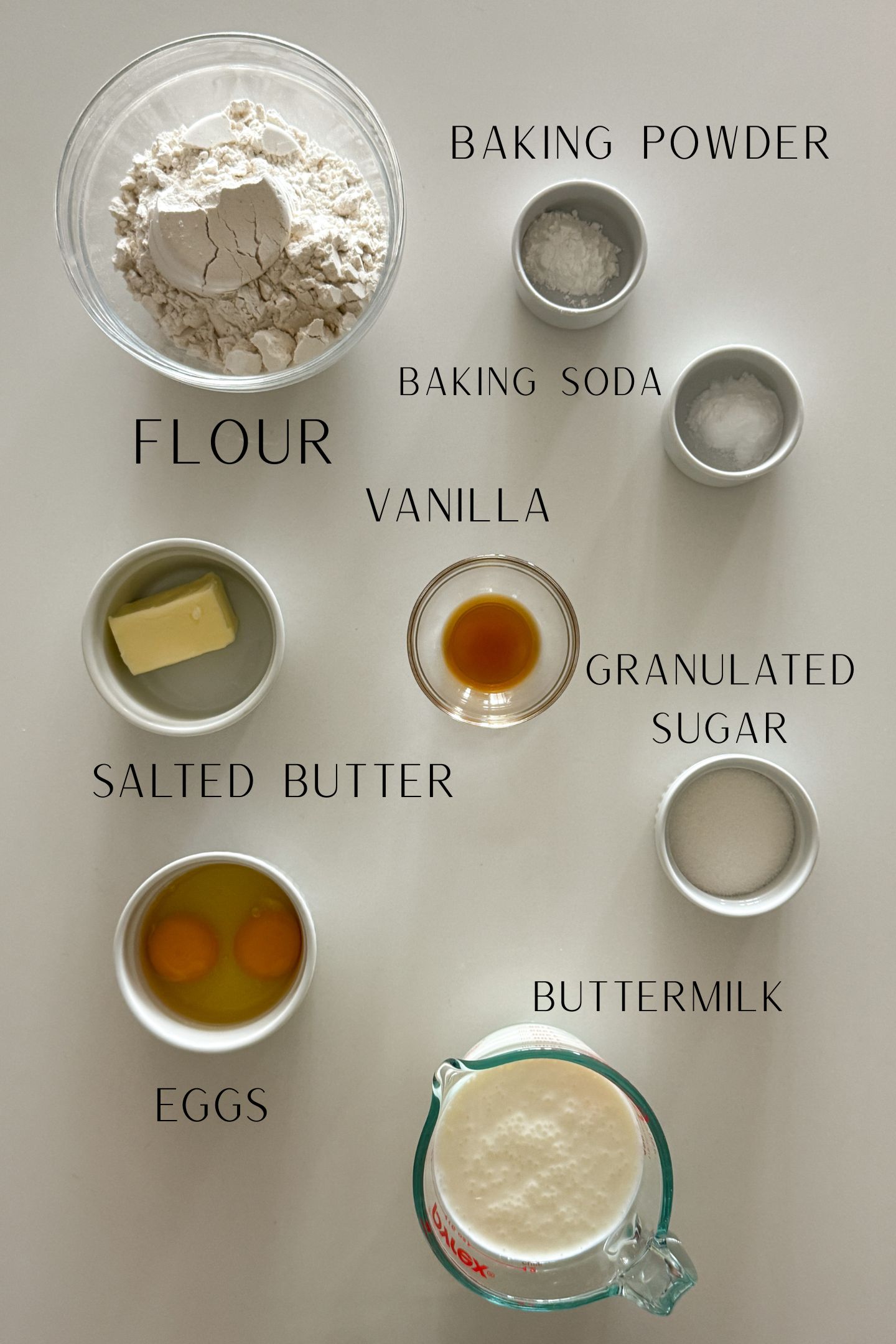 Ingredients measured out in bowls to make the buttermilk pancakes.