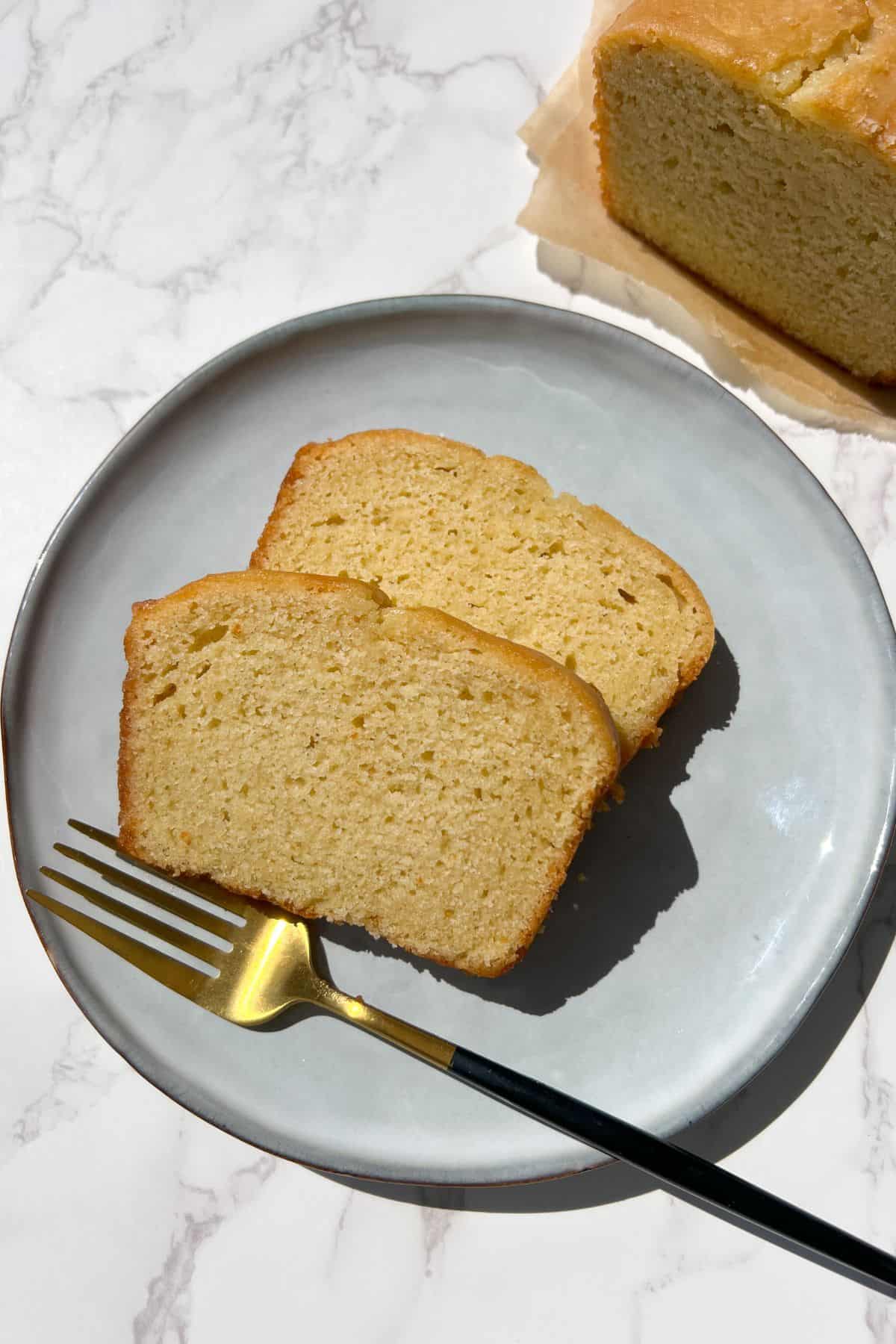 Slices of Starbucks Lemon Loaf on a plate with a fork.