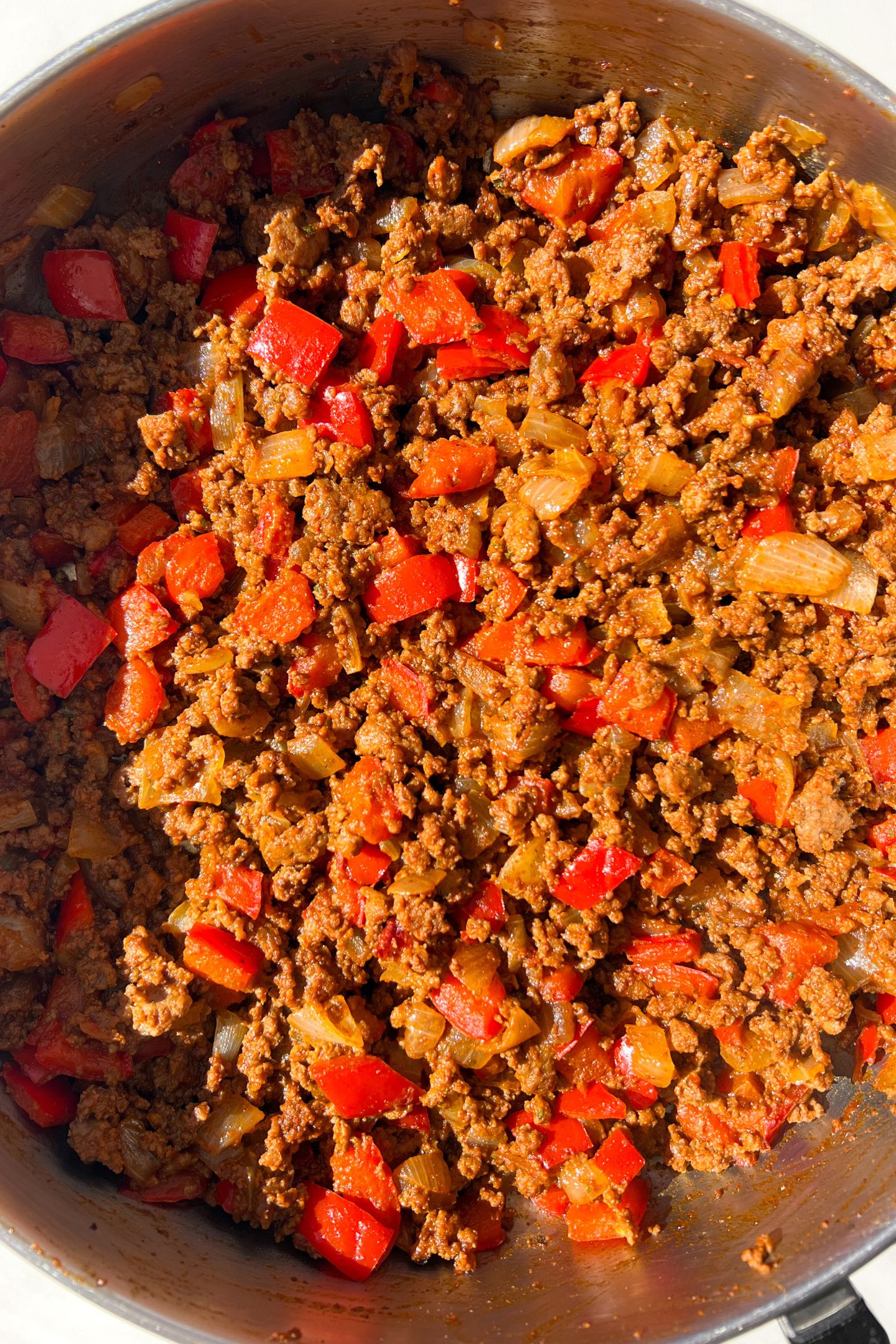 Cooked ground beef, peppers and onions