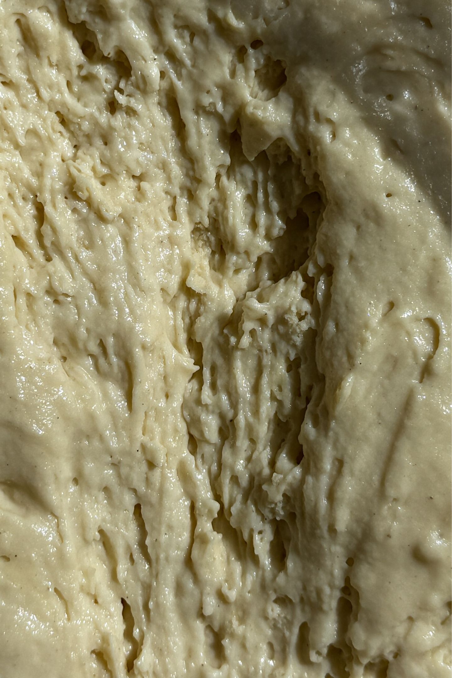 Scooping the pancake batter in the bowl.