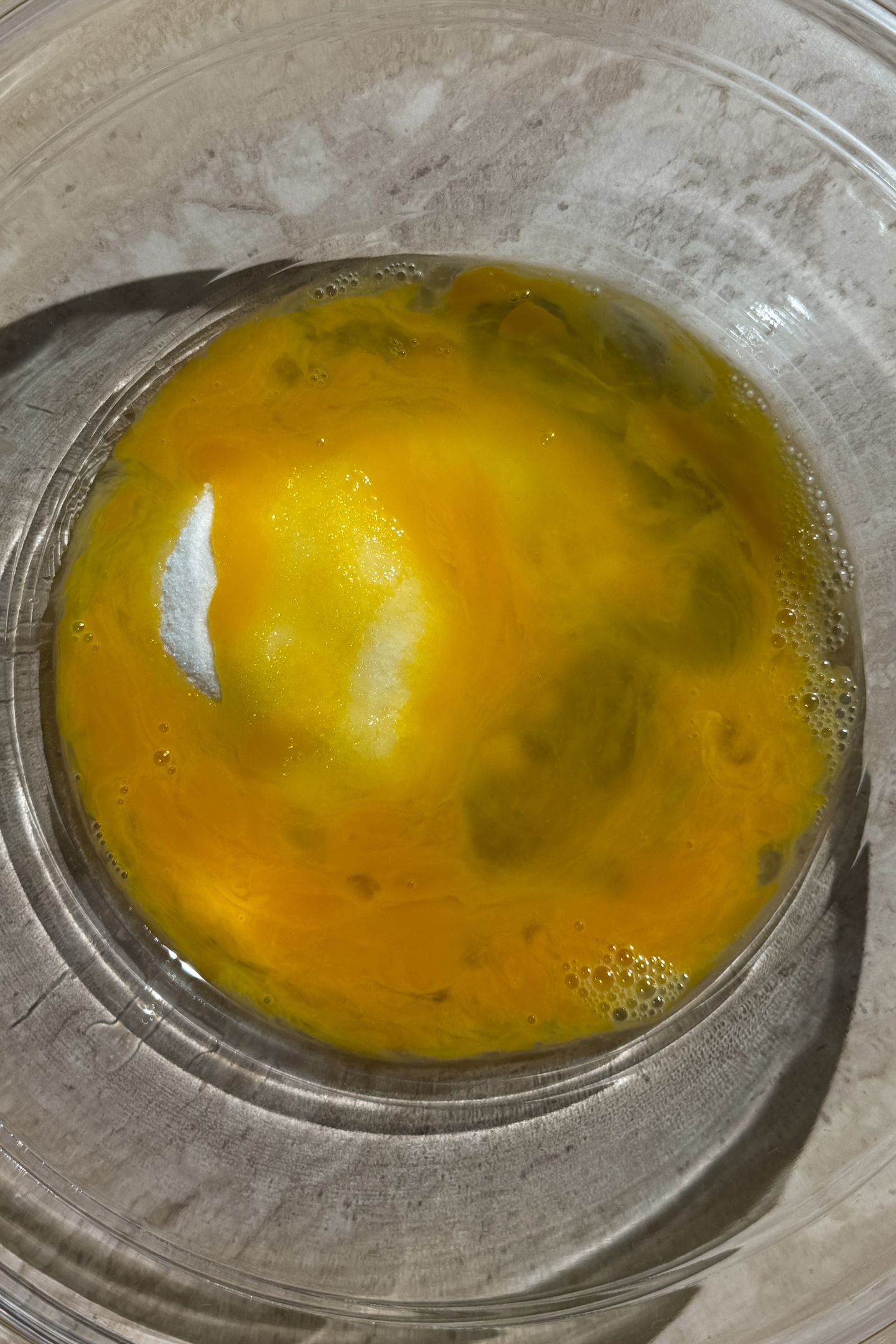 Whisked eggs and sugar in a bowl.