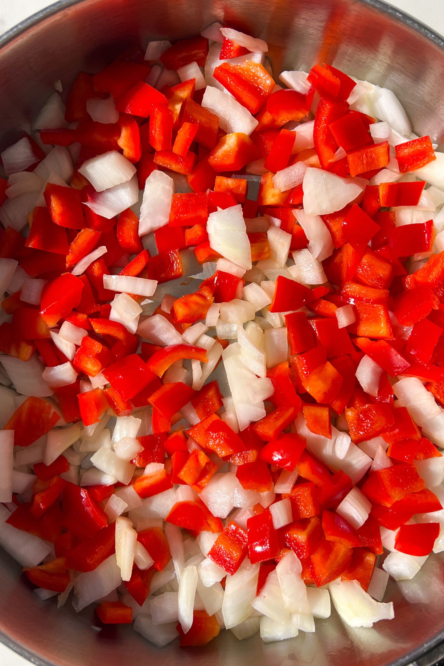 Diced onion and peppers in a pan