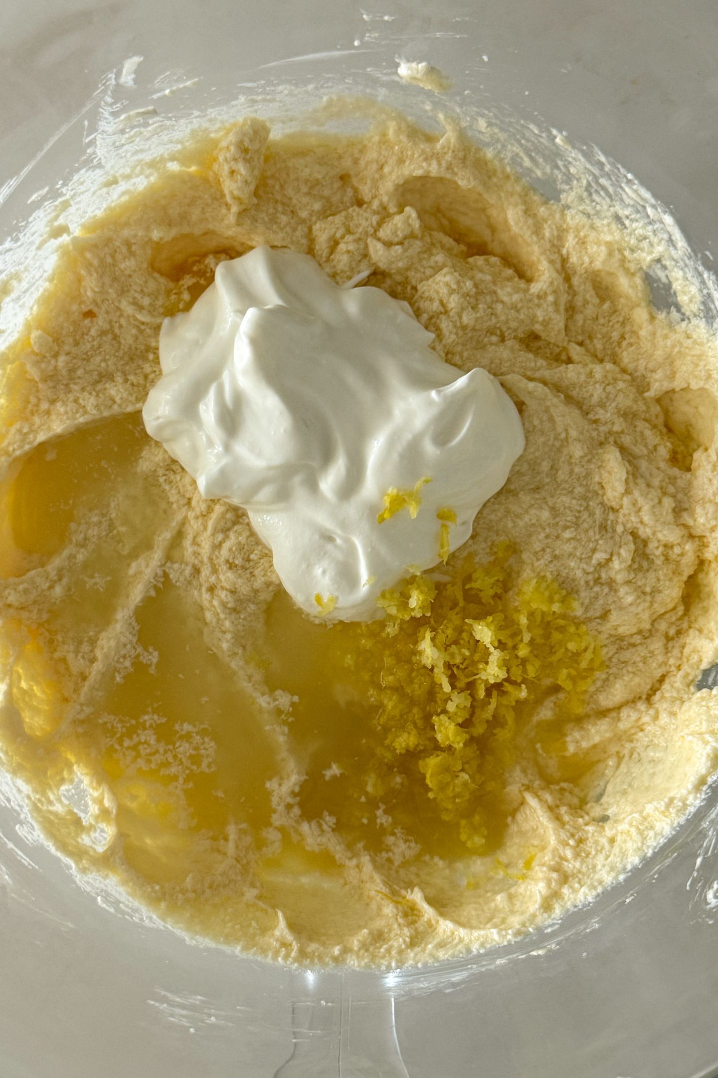 Adding the sour cream, lemon zest and lemon juice to the other wet ingredients.