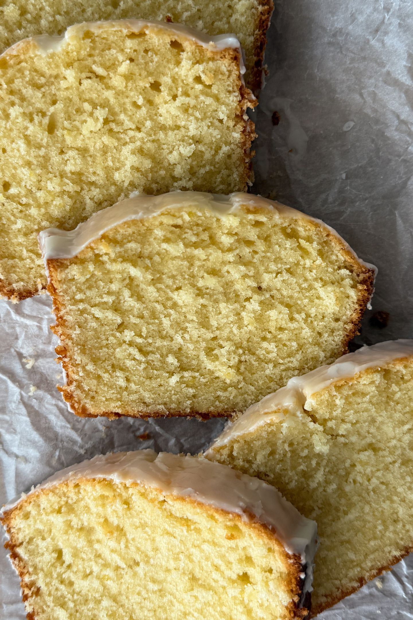 Slices of lemon pound cake resting on each other on a platter.