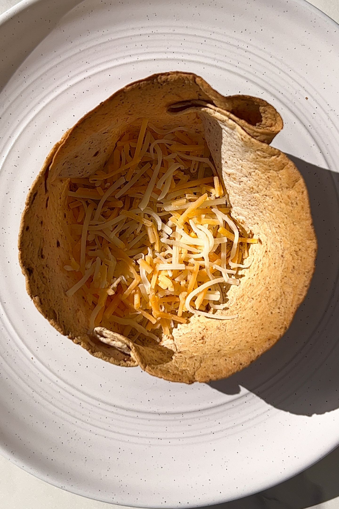 Cheese added to the bottom of the homemade taco cup.