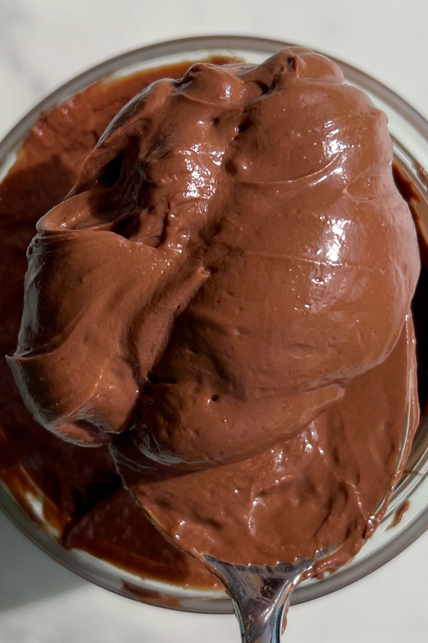 A spoonful of protein chocolate mousse on a spoon.