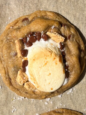 S'mores cookie on a baking sheet topped with flake sea salt.