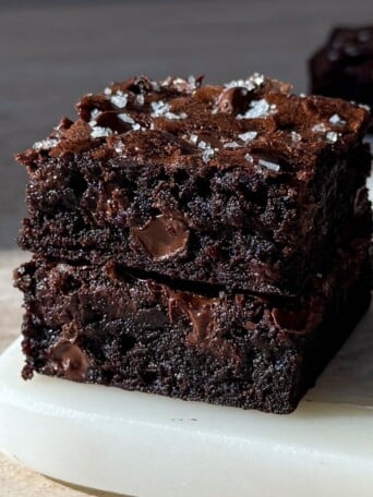 Two Espresso Brownies stacked on top of each other on a plate.
