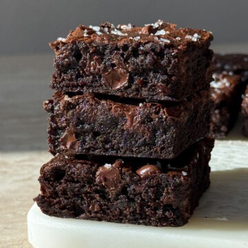 A stack of espresso brownies topped with sea salt flakes.