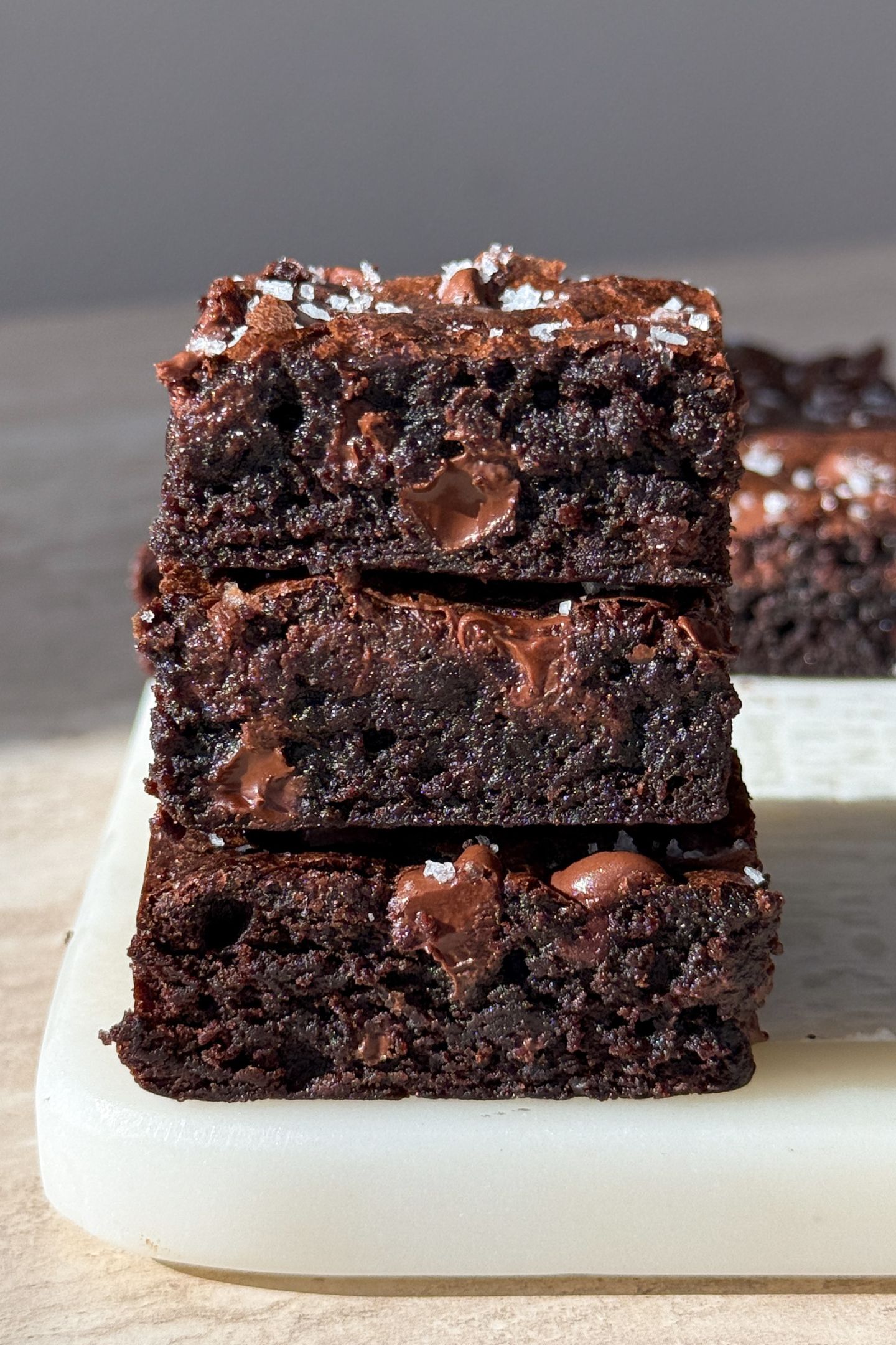A stack of espresso brownies topped with sea salt flakes.