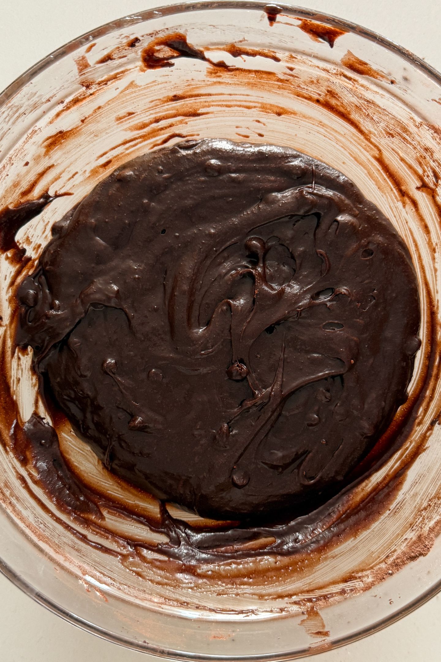 Chocolate chips folded in the brownie batter in a mixing bowl.