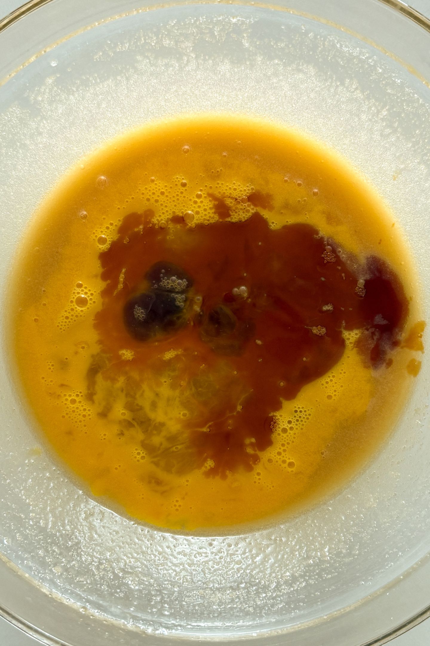Adding the remaining wet ingredients to the mixing bowl.