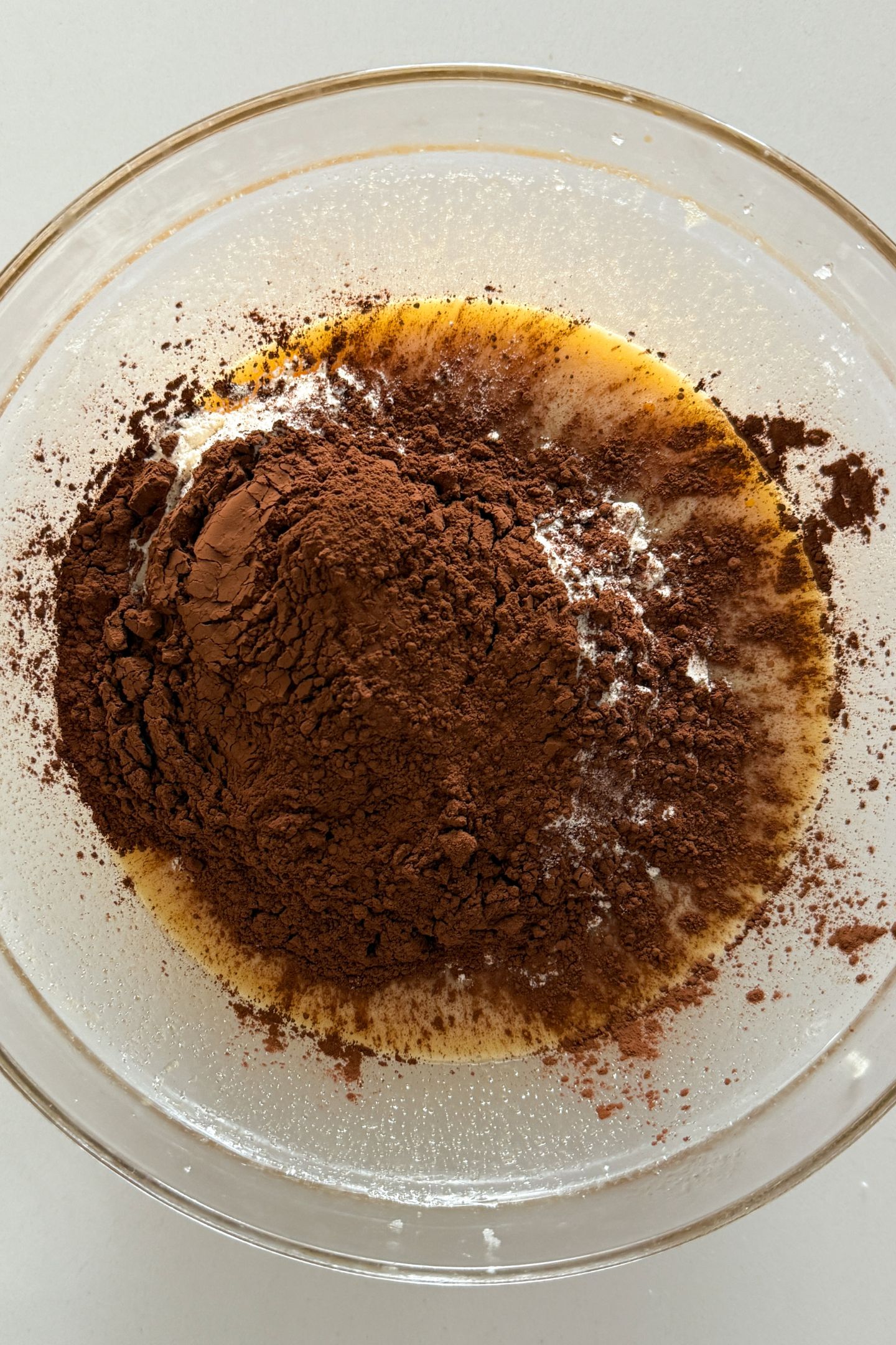 Cocoa powder added on top of the flour in the mixing bowl.