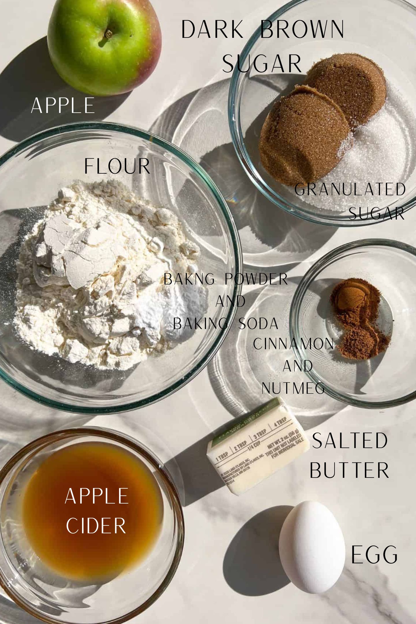 Ingredients measured out in bowls to make apple cider donuts.