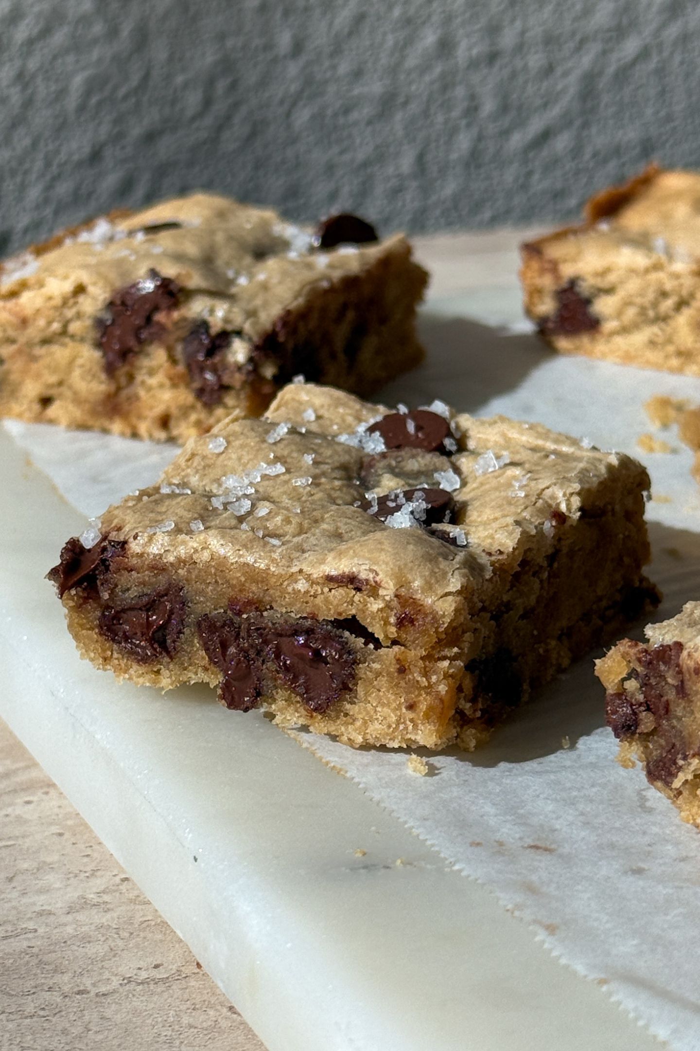 Side view of a blondie showing the chocolate chips and salt on top.