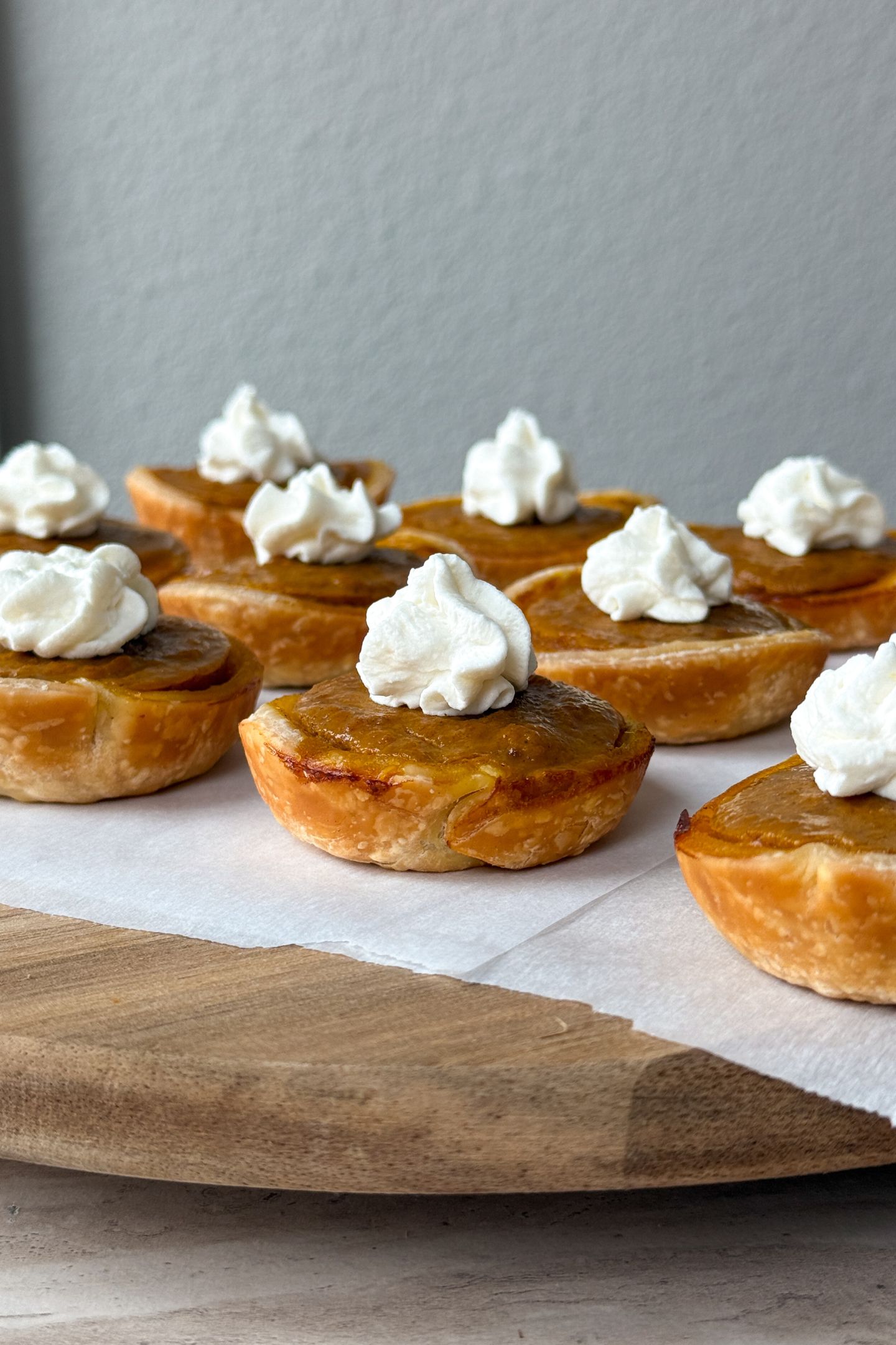 Mini Pumpkin Pies topped with homemade whipped cream.