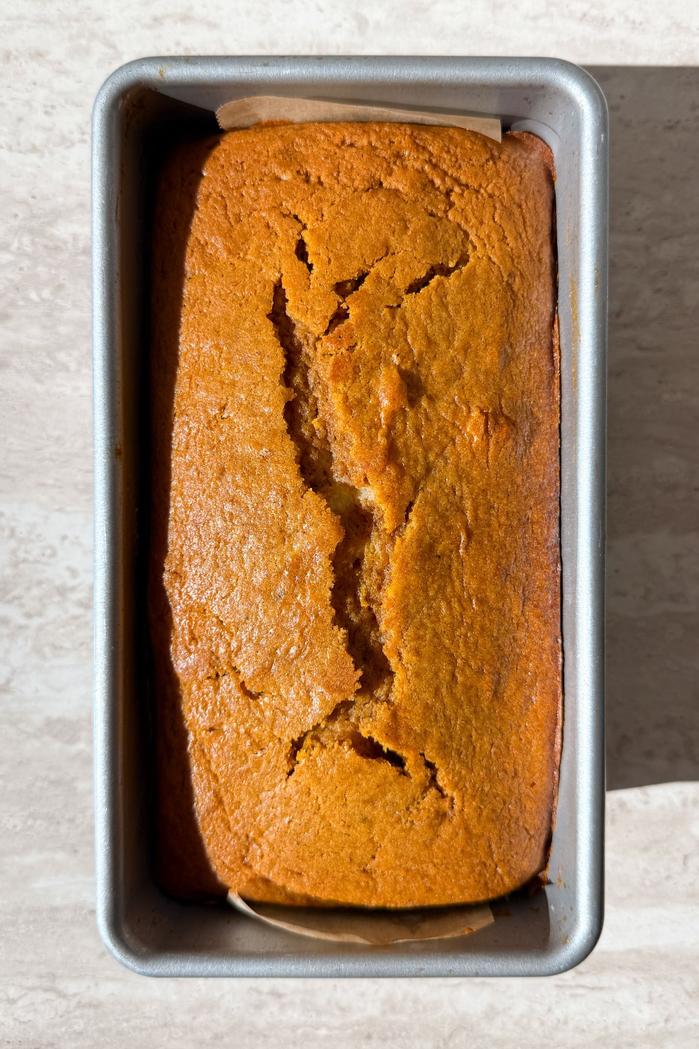 Baked pumpkin cheesecake bread in the loaf pan.
