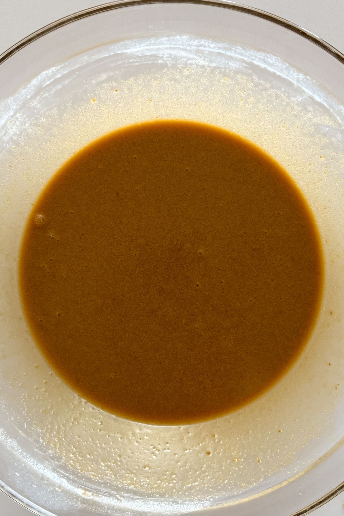 Wet ingredients mixed together in a large mixing bowl.