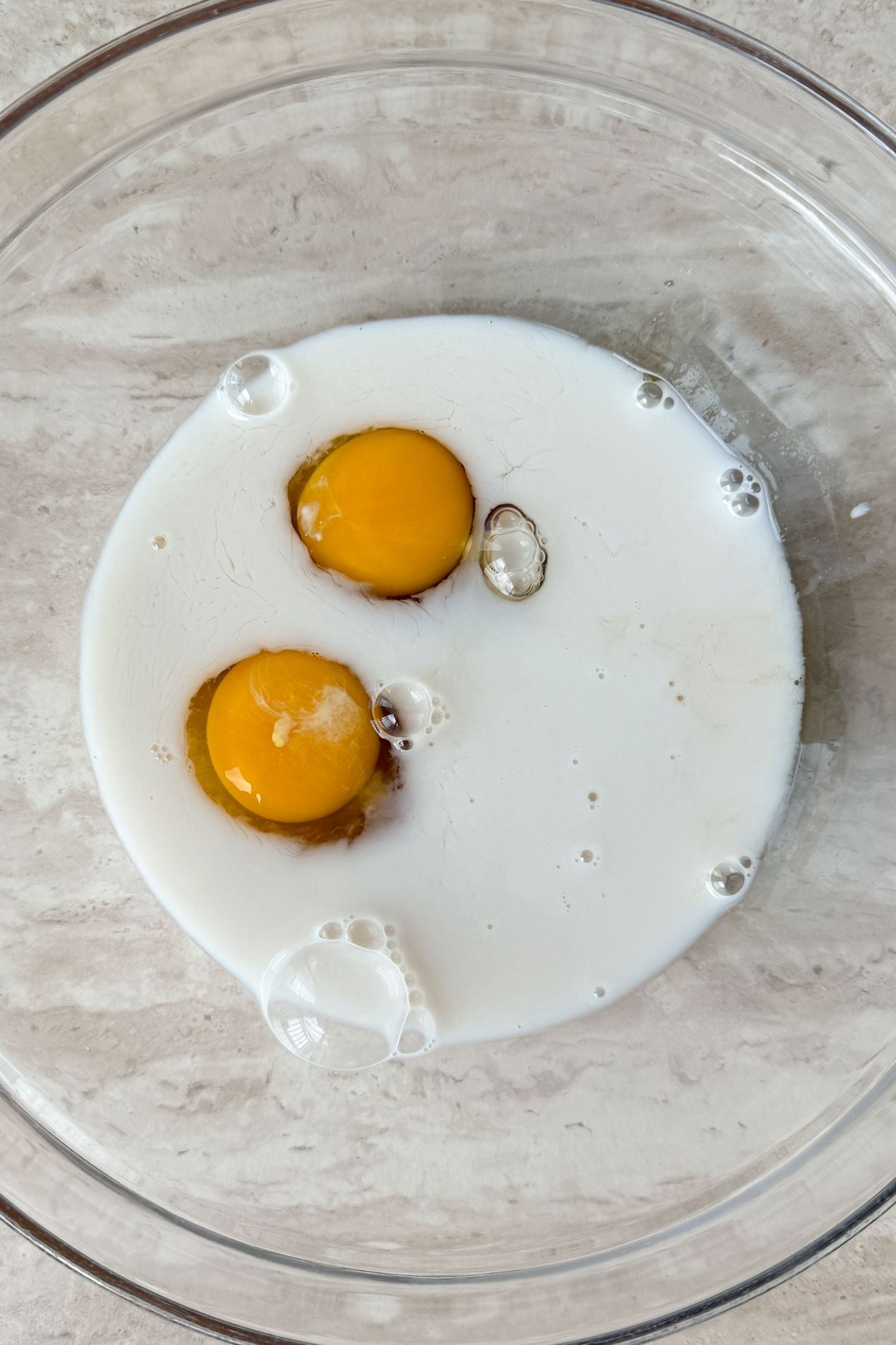Eggs and milk in a mixing bowl.