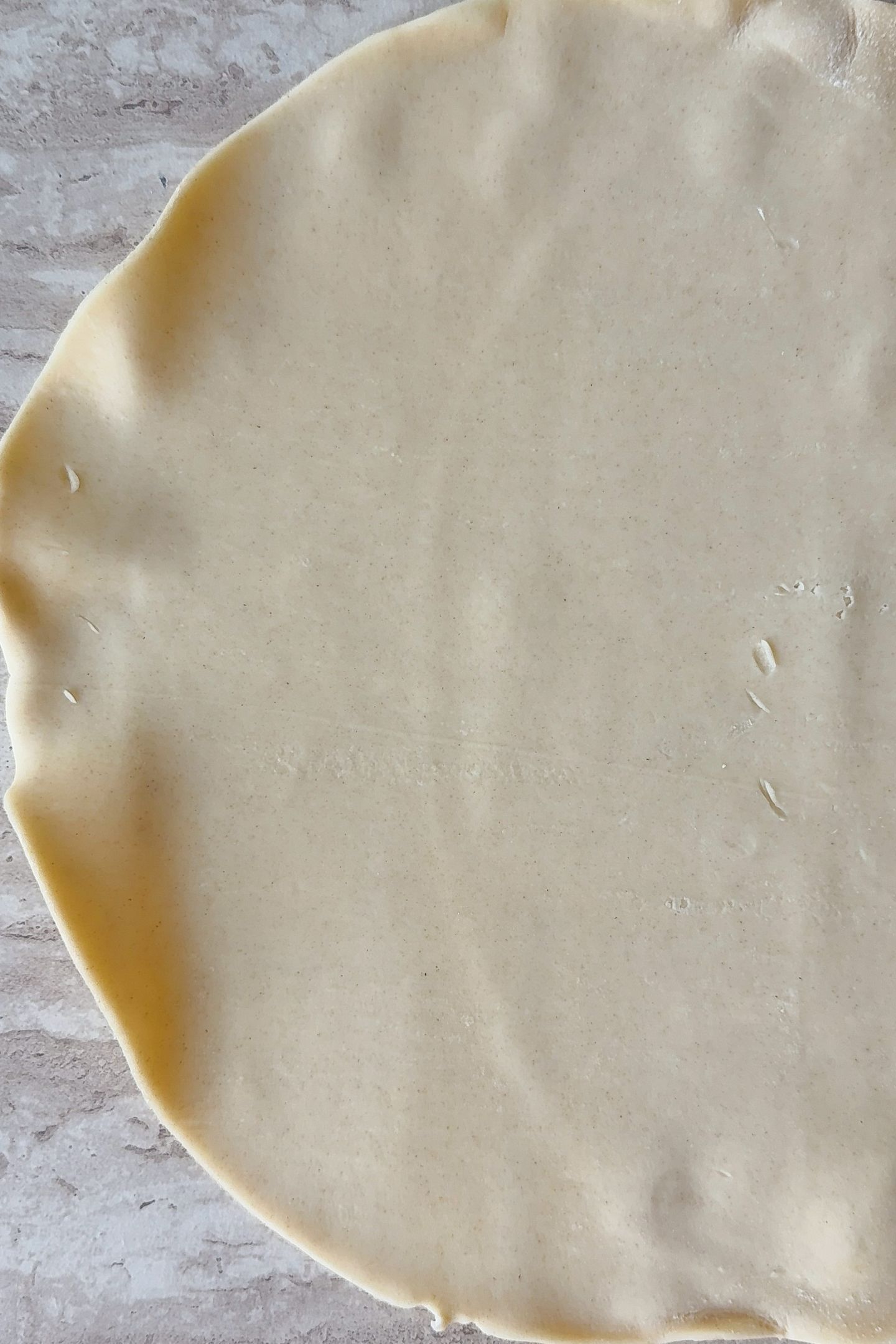 Rolled out pre-made pie crust that is thawed to room temperature.
