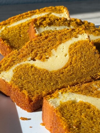 Slices of Pumpkin Cheesecake Bread on a serving platter.