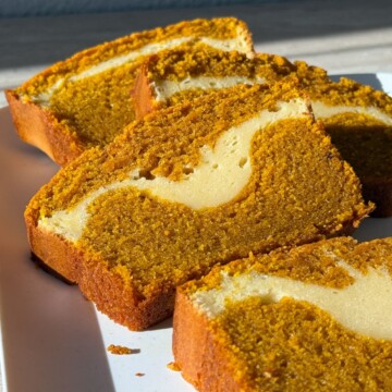 Slices of Pumpkin Cheesecake Bread on a serving platter.