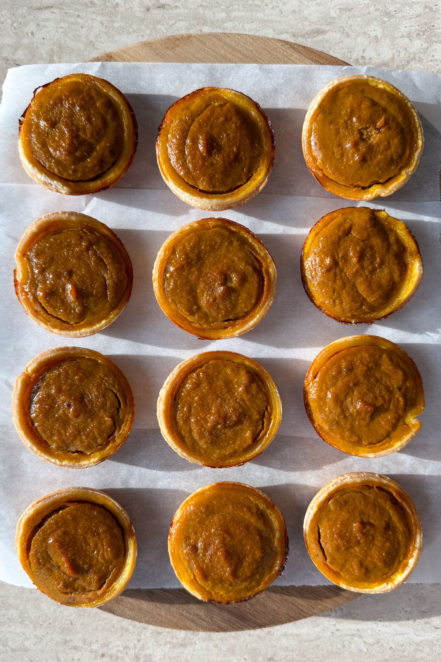 Mini Pumpkin Pies on a platter on top of parchment paper.