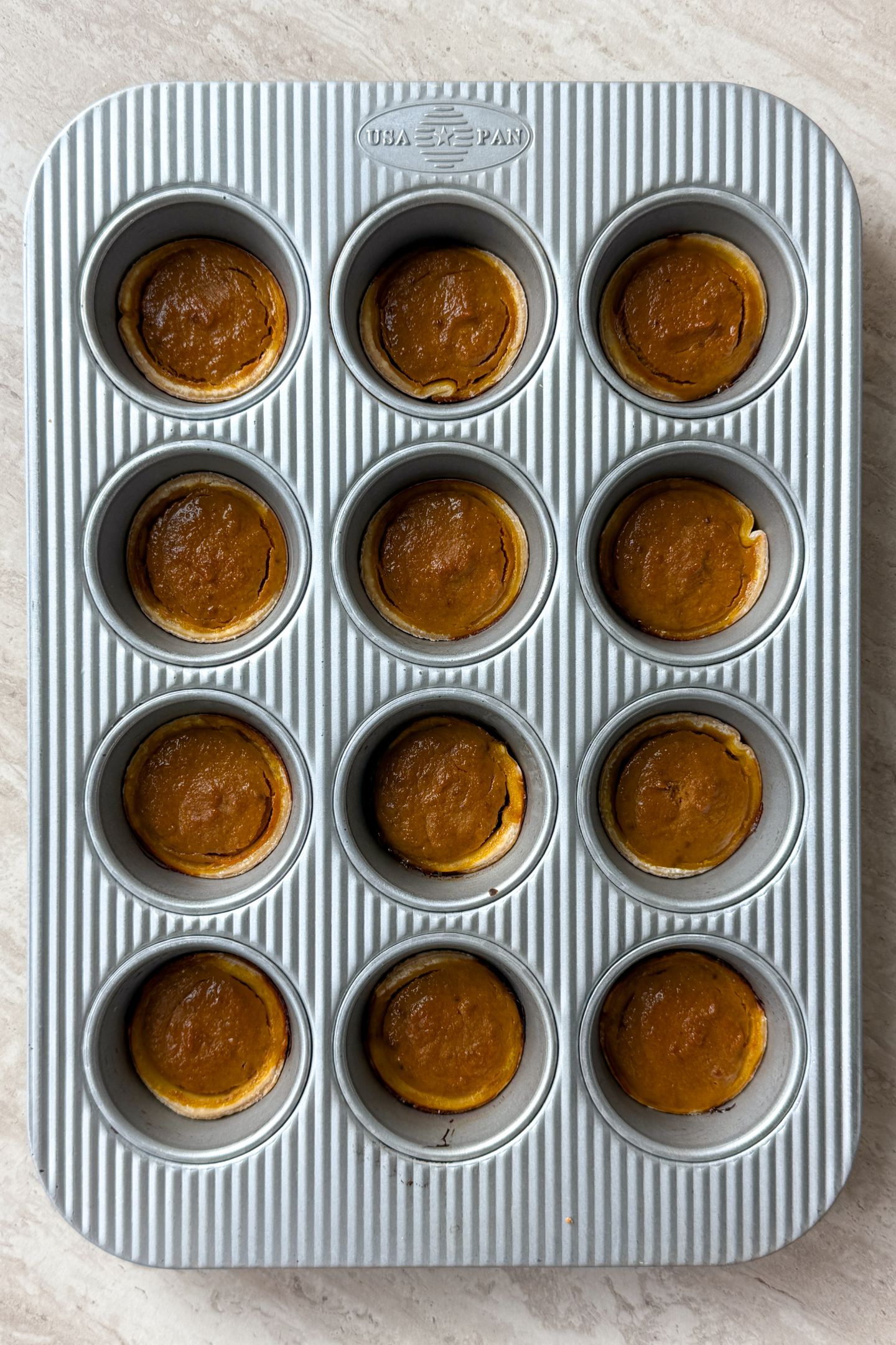 Baked Mini Pumpkin Pies in the muffin tin.