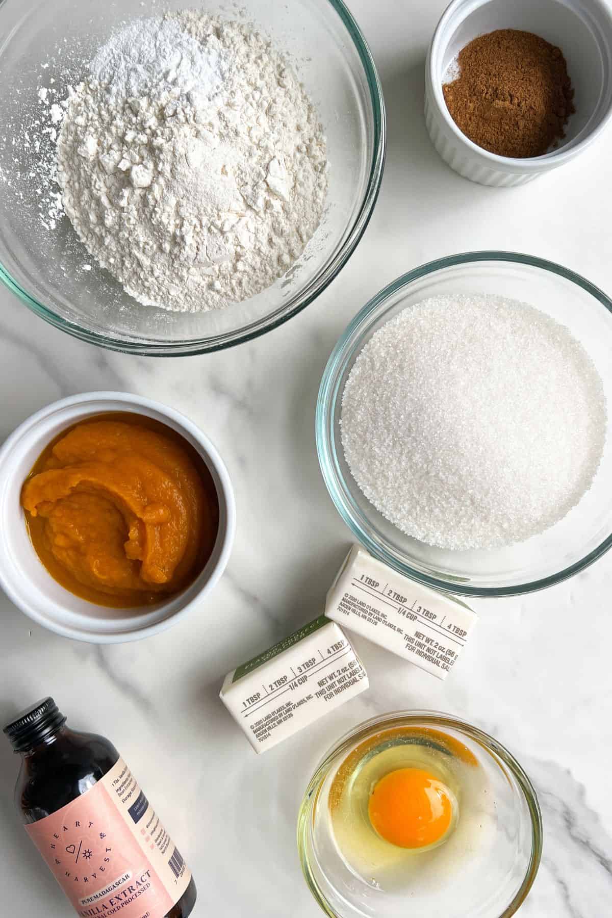 Ingredients measured out in bowls to make Pumpkin Bread with Cream Cheese Frosting