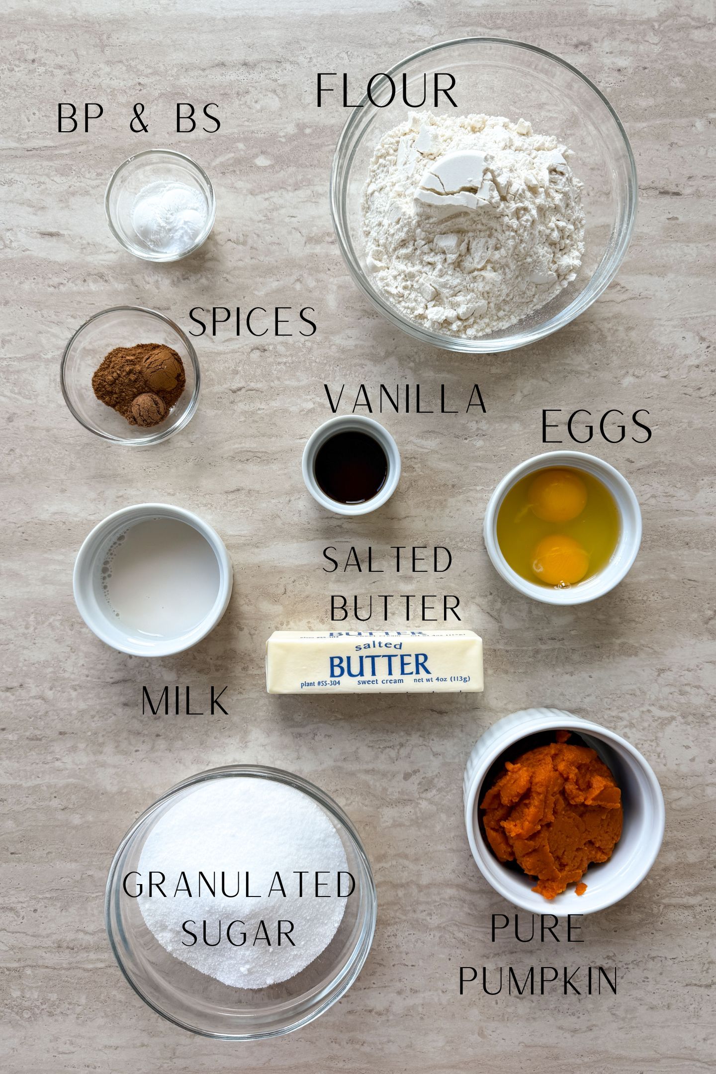 Ingredients measured out in bowls to make the pumpkin bread.