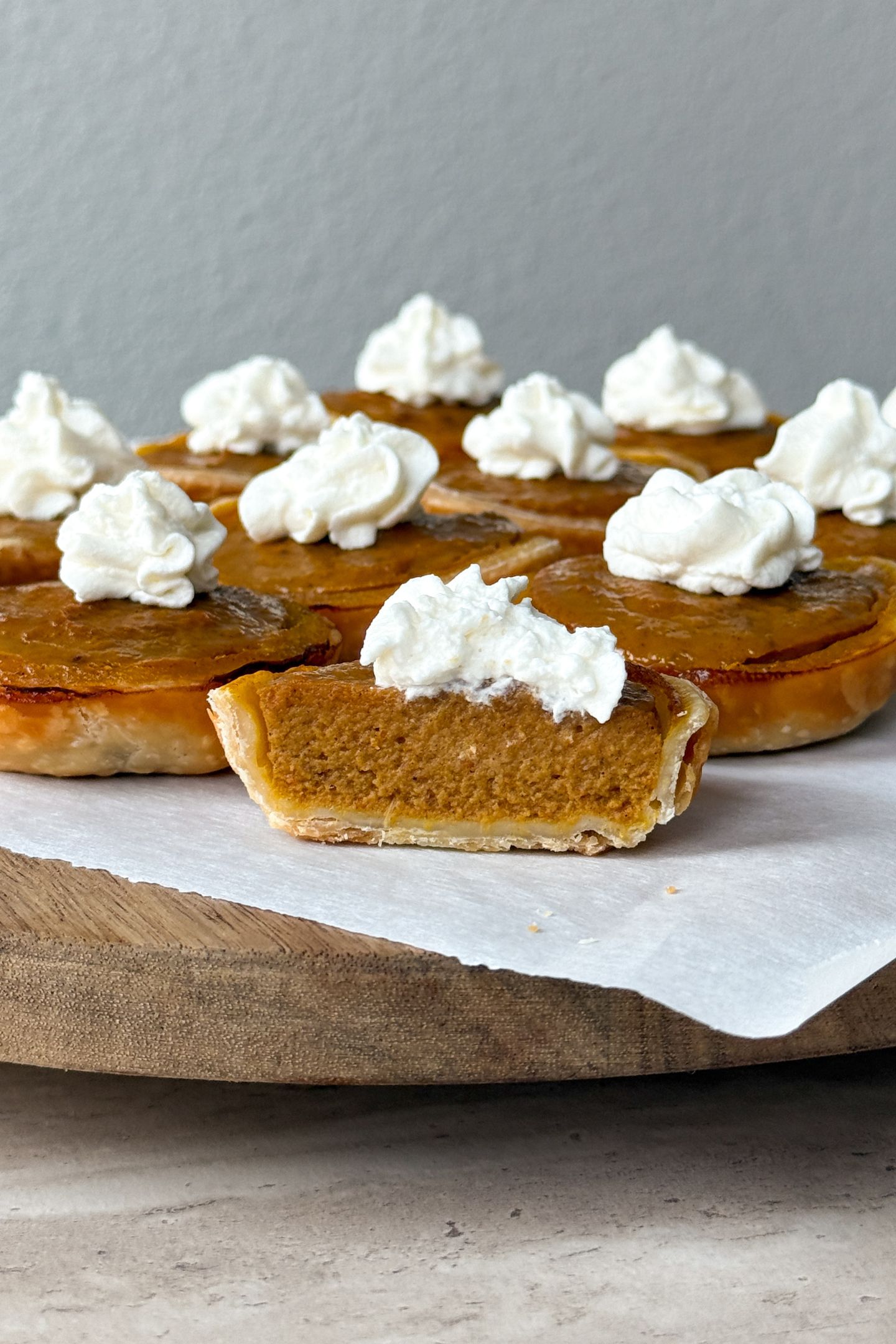 A pumpkin pie cut in half to show the inside filling texture.