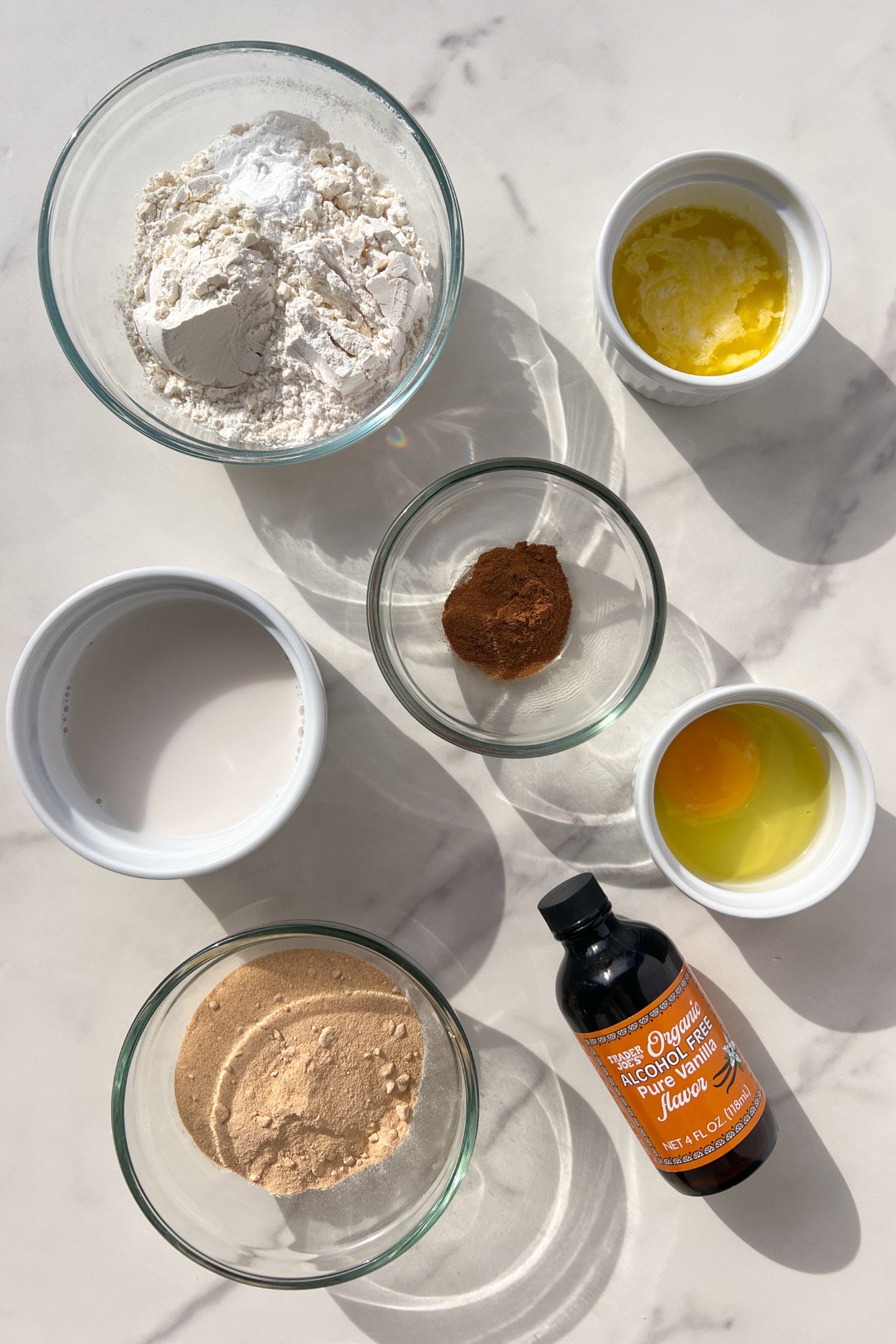 Ingredients measured out in bowls to make Cinnamon Sugar donuts.